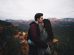 man kissing woman's forehead